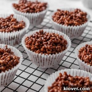 A close-up of a single chocolate rice crispy cake on a cooling rack.