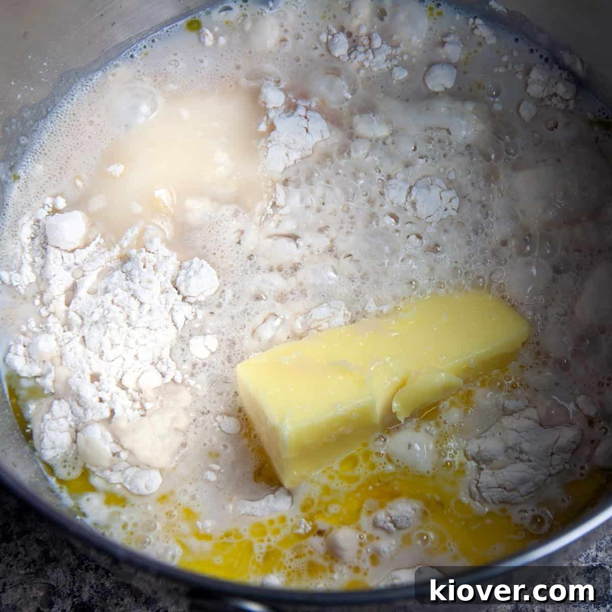Unmixed dough ingredients in mixing bowl.
