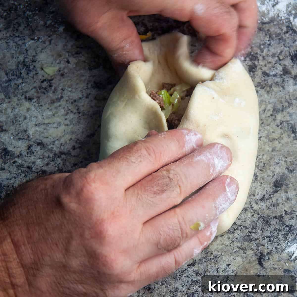 Wrapping bierocks, showing dough being folded over the filling.