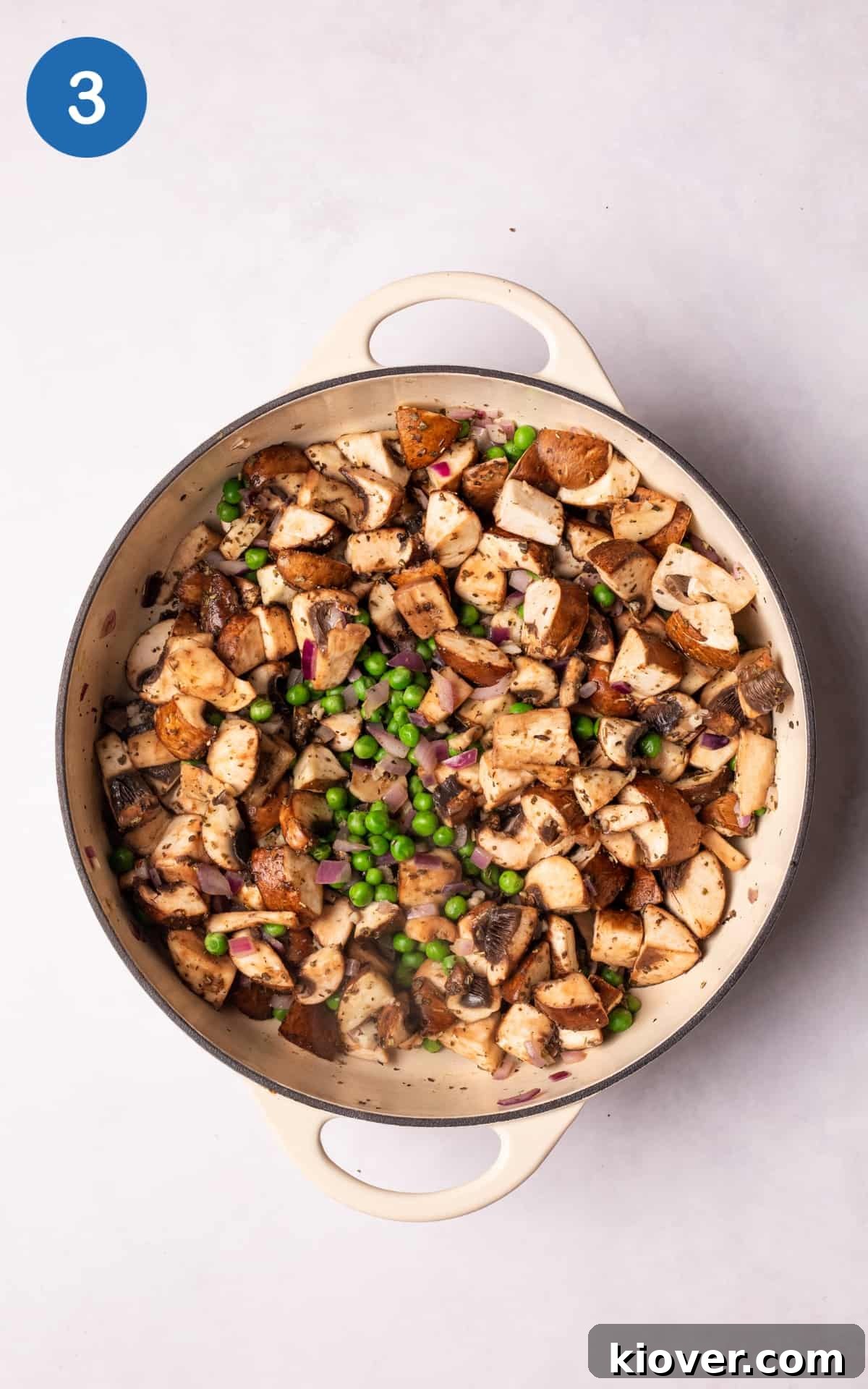 Chestnut mushrooms, frozen peas, and dried sage cooking in a pan with sautéed aromatics.