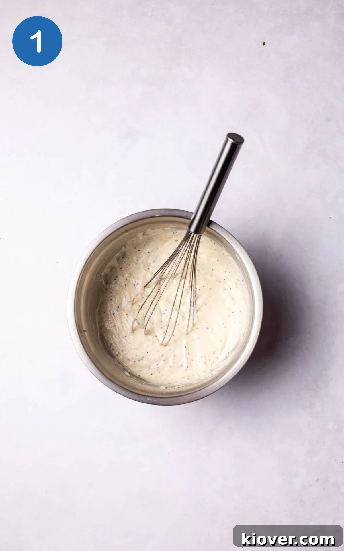 Mixing the dry and wet ingredients for gluten-free pancakes in a large bowl until smooth.