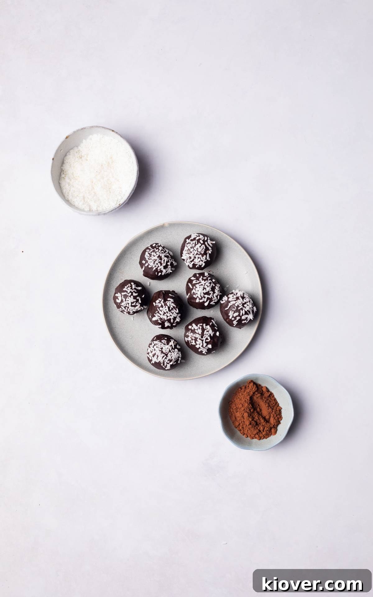 Chocolate Coconut Balls served on a plate, beautifully topped with a sprinkle of coconut flakes.