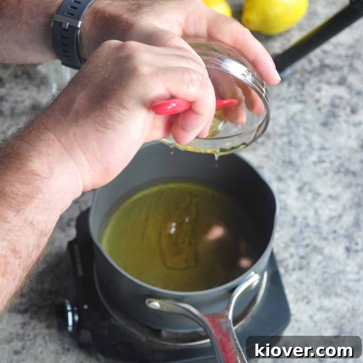 Zesty 3 Ingredient Honey Lemonade Naturally Sweetened 2 Using a spatula to put honey into a saucepan.