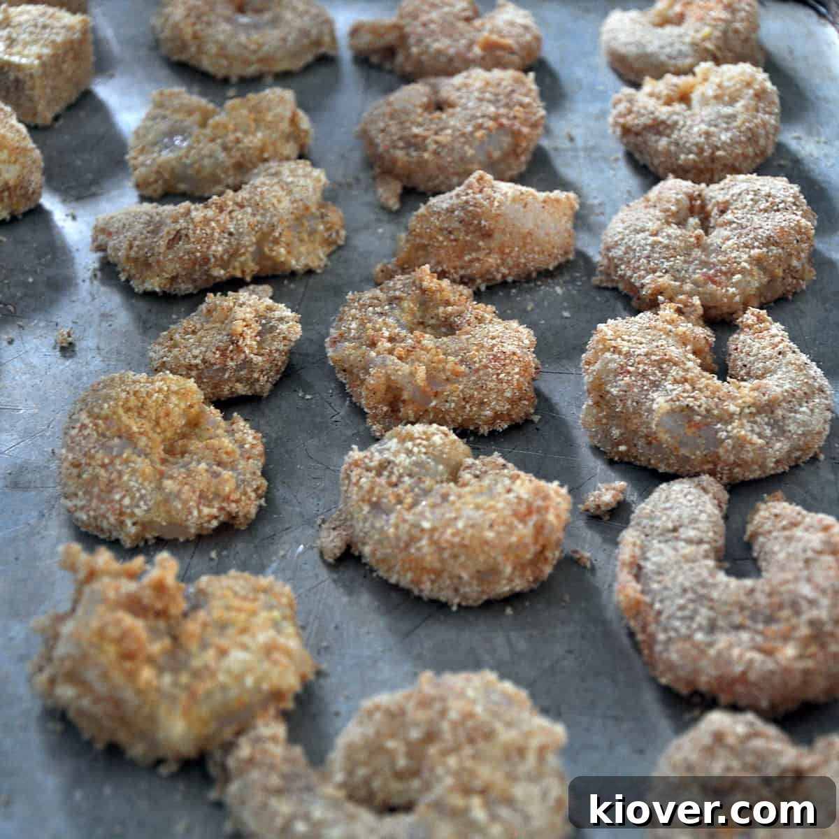 Baked Shrimp Breaded shrimp neatly arranged on a baking sheet, ready for the oven.