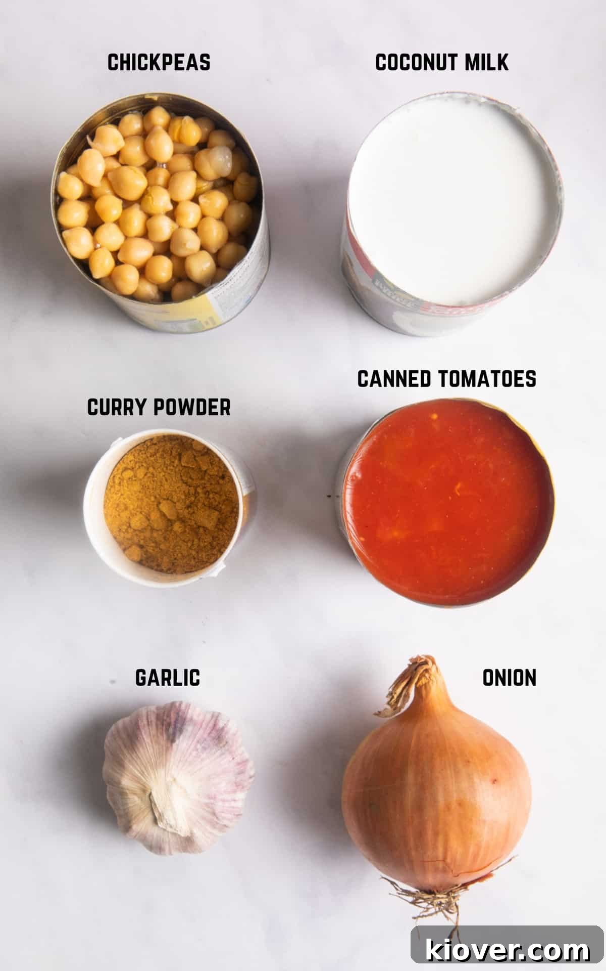 Hearty Slow Cooker Chickpea Curry 3 Ingredients for chickpea curry in cans on a white surface.