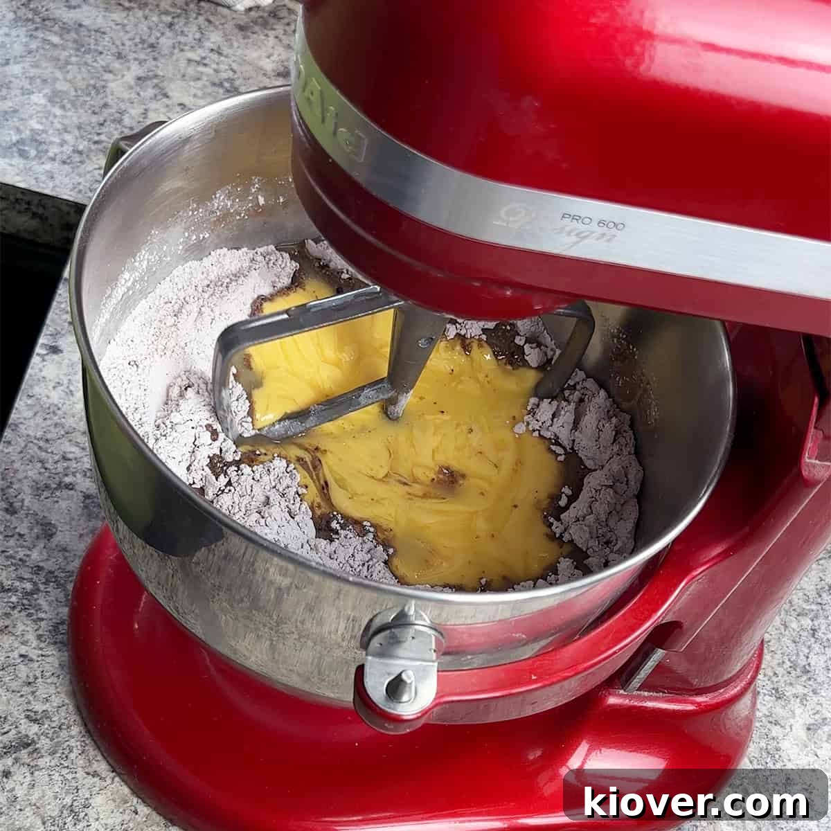 Adding the melted Velveeta and butter mixture to the dry ingredients.