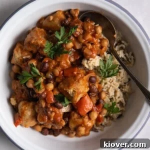 close overhead shot of Slow Cooker Sausage Casserole with brown rice in a white bowl.