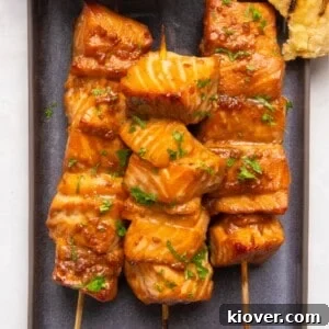 Asian salmon skewers on a plate.