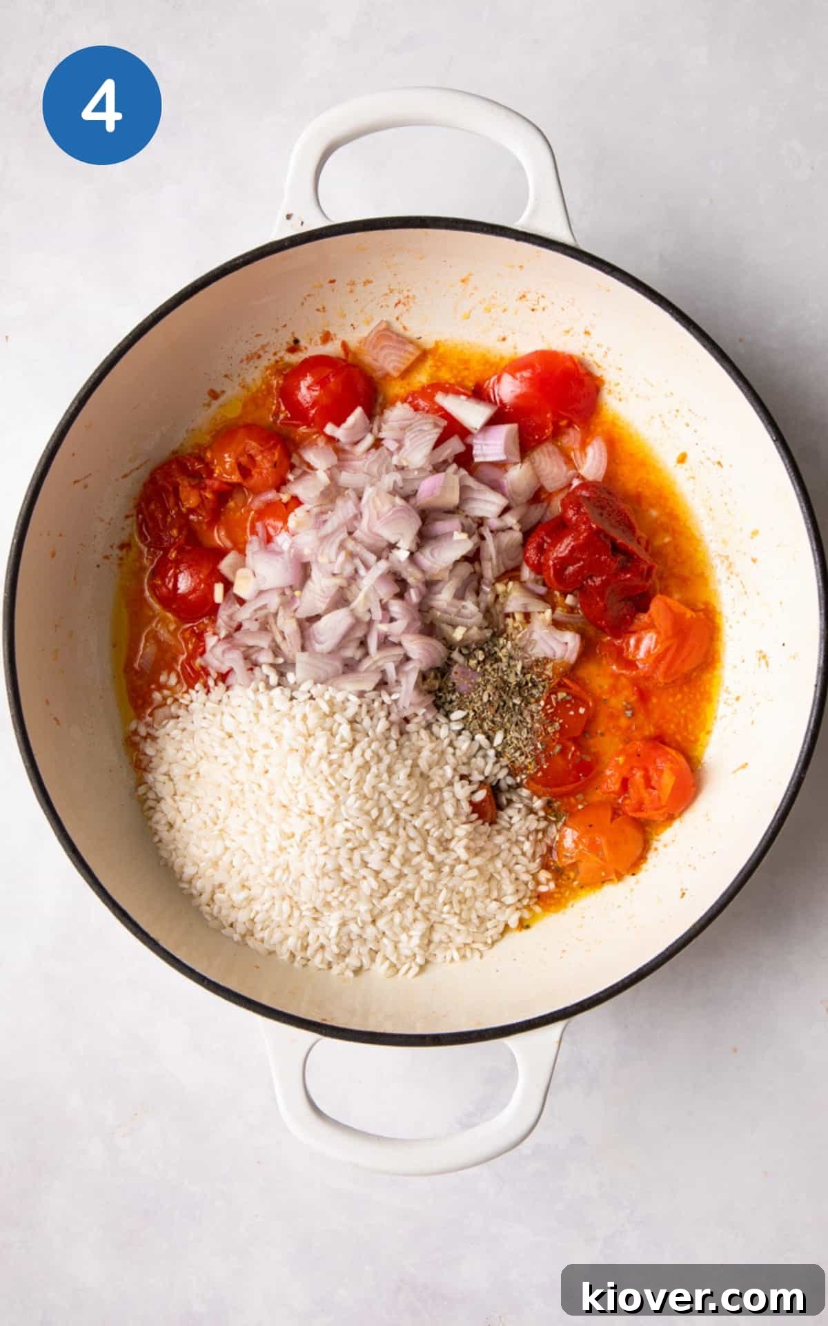 Shallot, garlic, sage, tomato puree, and Arborio rice being added to the pan with squashed tomatoes, ready for sautéing.