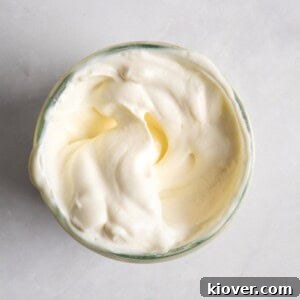 homemade vegan mayonnaise in a jar served on a white background.