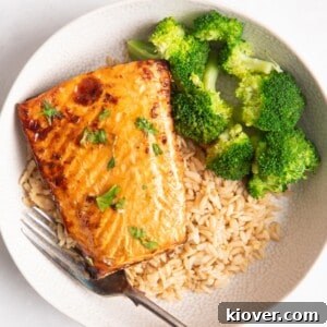 salmon on a bed of rice served with broccoli