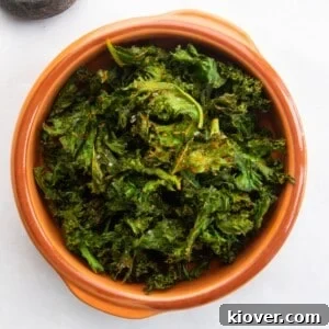 Close-up of golden, crispy air fryer kale chips in a bowl.