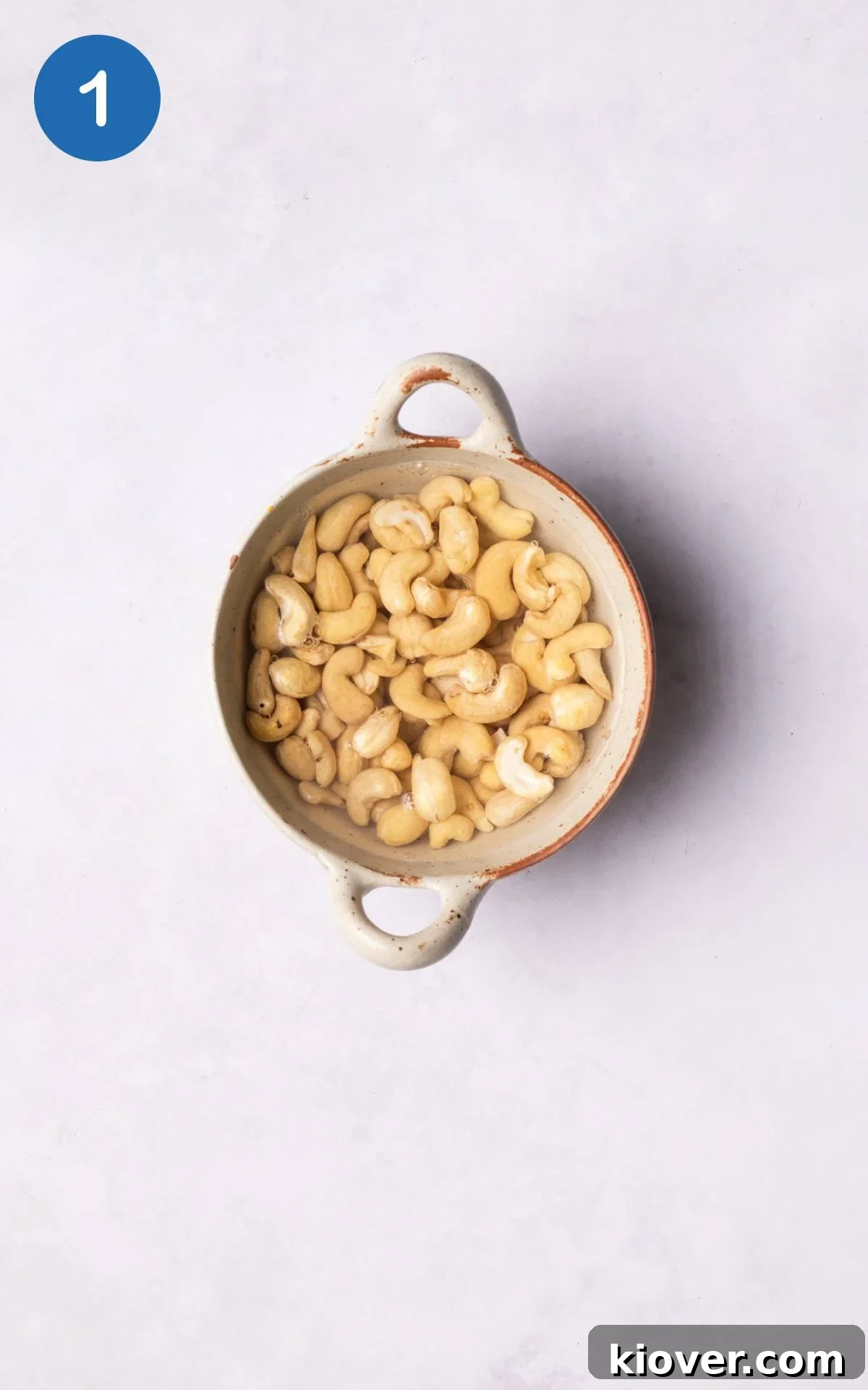 Velvety Cashew Cream 4 Raw cashews soaking in a bowl with hot water.