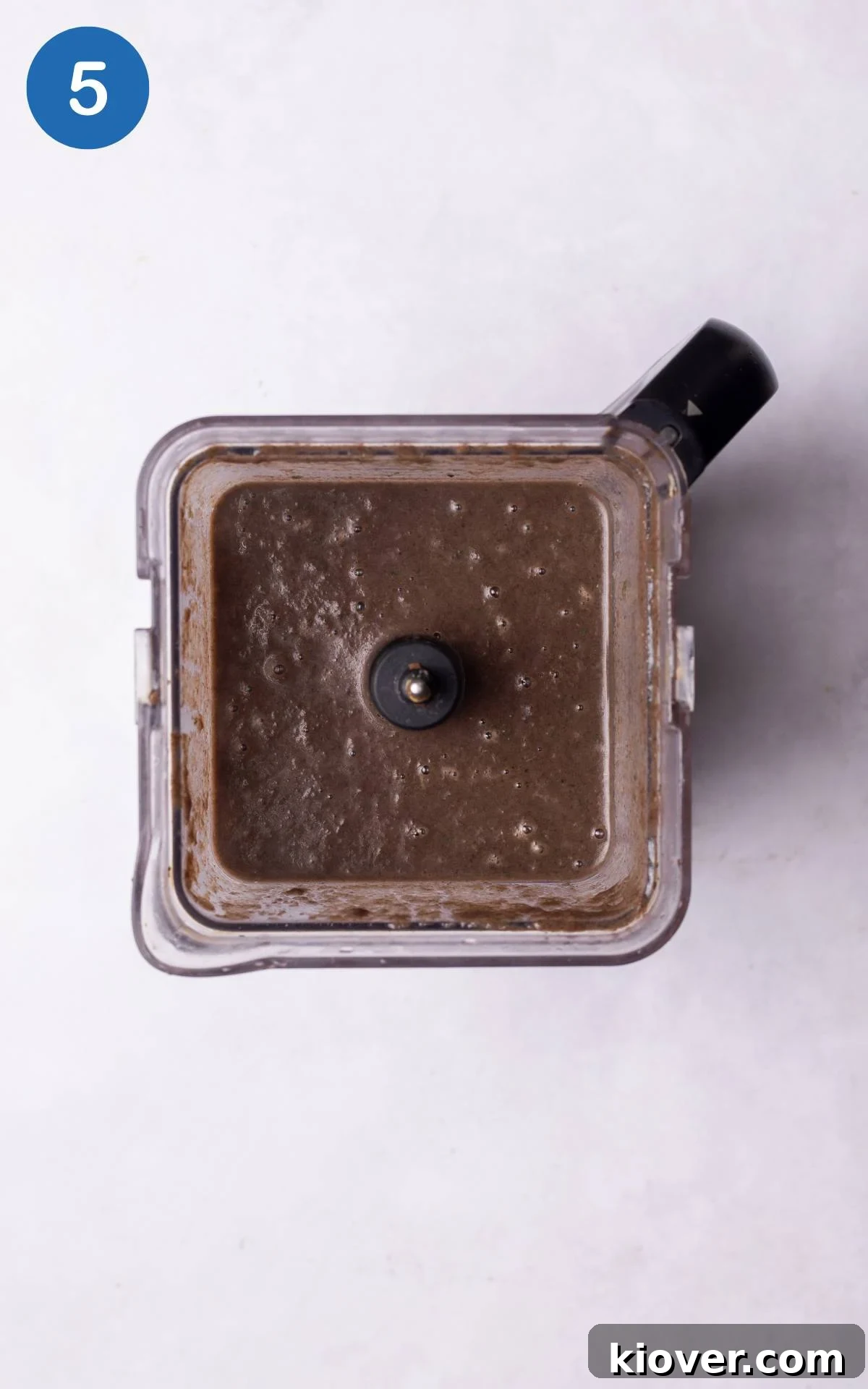 The simmering mushroom soup mixture being blended in a high-speed blender until it achieves a smooth, creamy consistency.