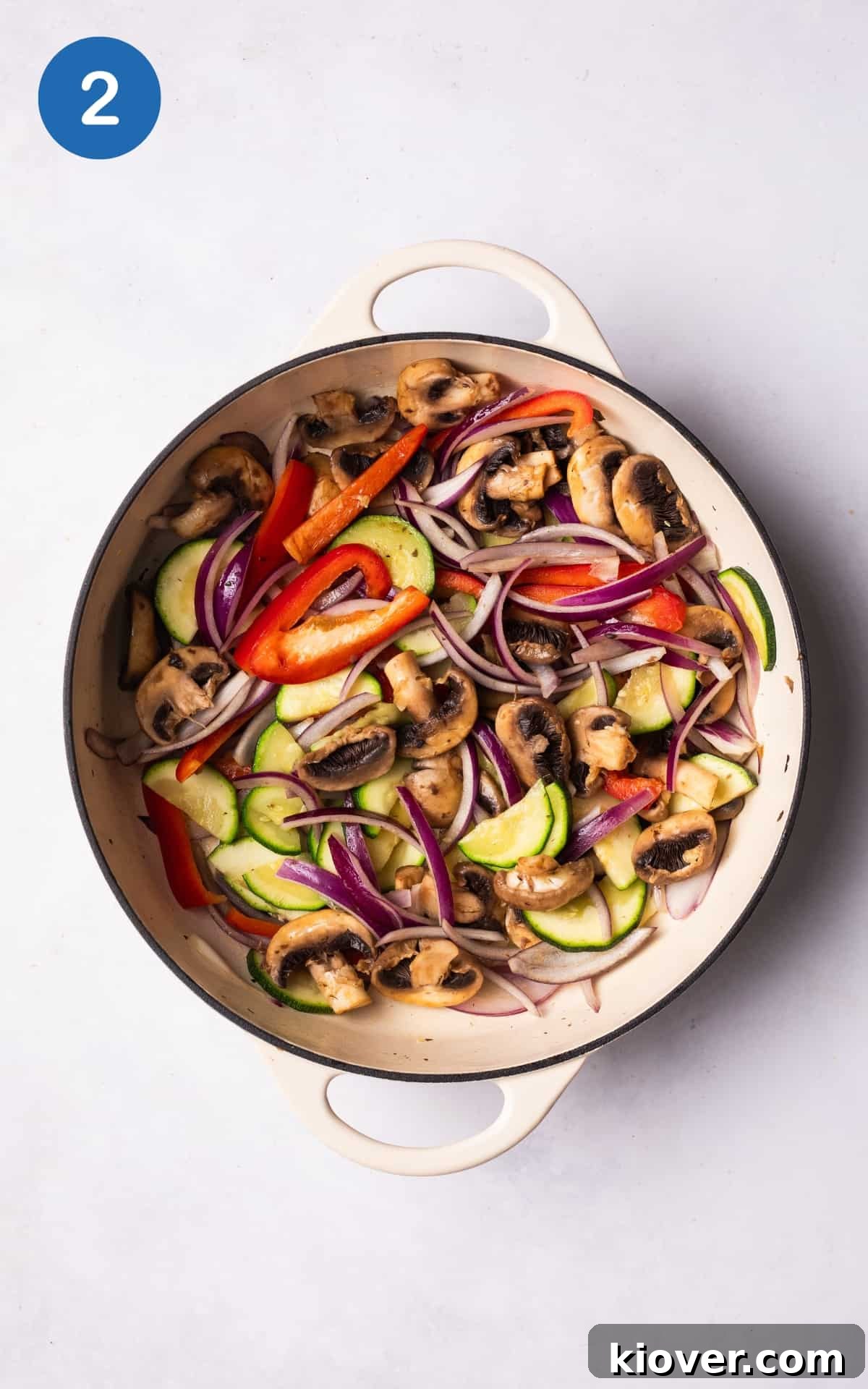 olive oil and vegetables cooking in a pan.