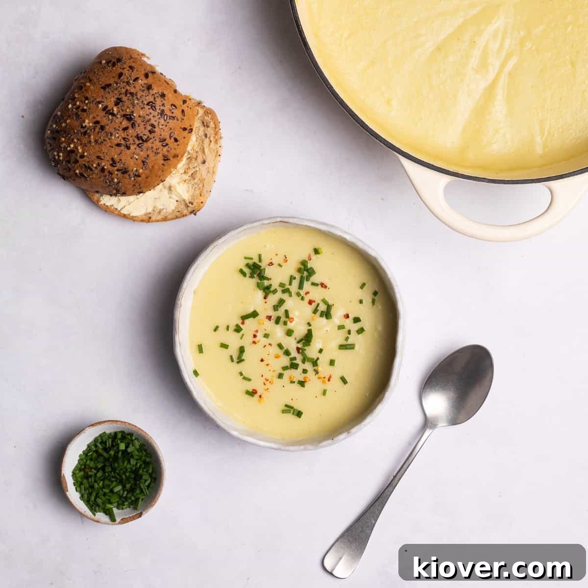 Leek and Potato Soup served in a bowl, garnished with fresh chives and chilli flakes.