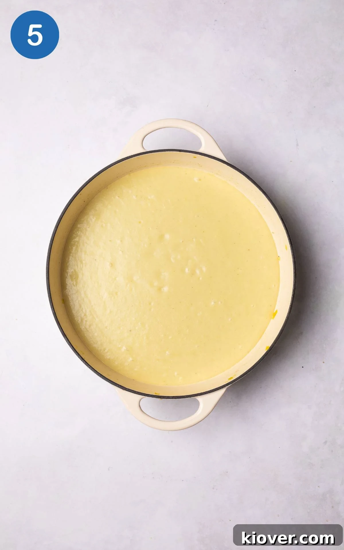 Smooth, yellow vegan leek and potato soup in a pot, ready to be served.