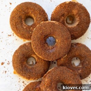 Stack of warm, sugar-dusted cinnamon baked doughnuts.