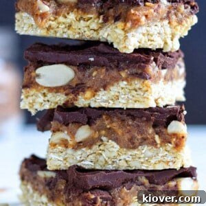 Stack of luscious vegan Snickers flapjacks, rich with caramel and peanuts.