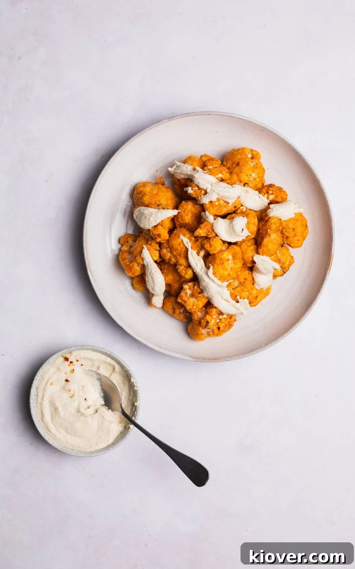 Crispy Air Fried Cauliflower 7 Perfectly air-fried cauliflower florets with a drizzle of sauce.
