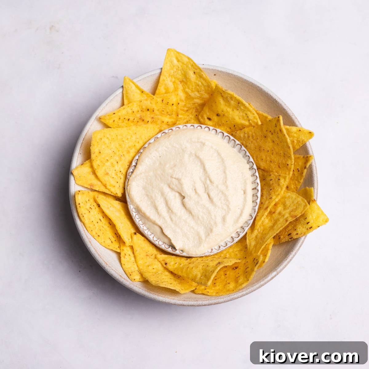 Creamy Vegan Sour Cream 2 A bowl of creamy vegan sour cream with a side of tortilla chips, ready for dipping.