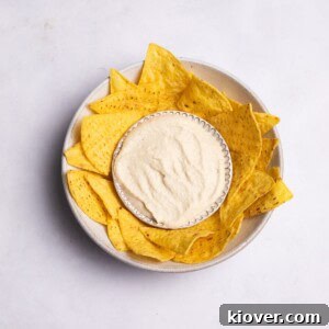 Creamy Vegan Sour Cream 7 A bowl of creamy vegan sour cream with chips ready for dipping.