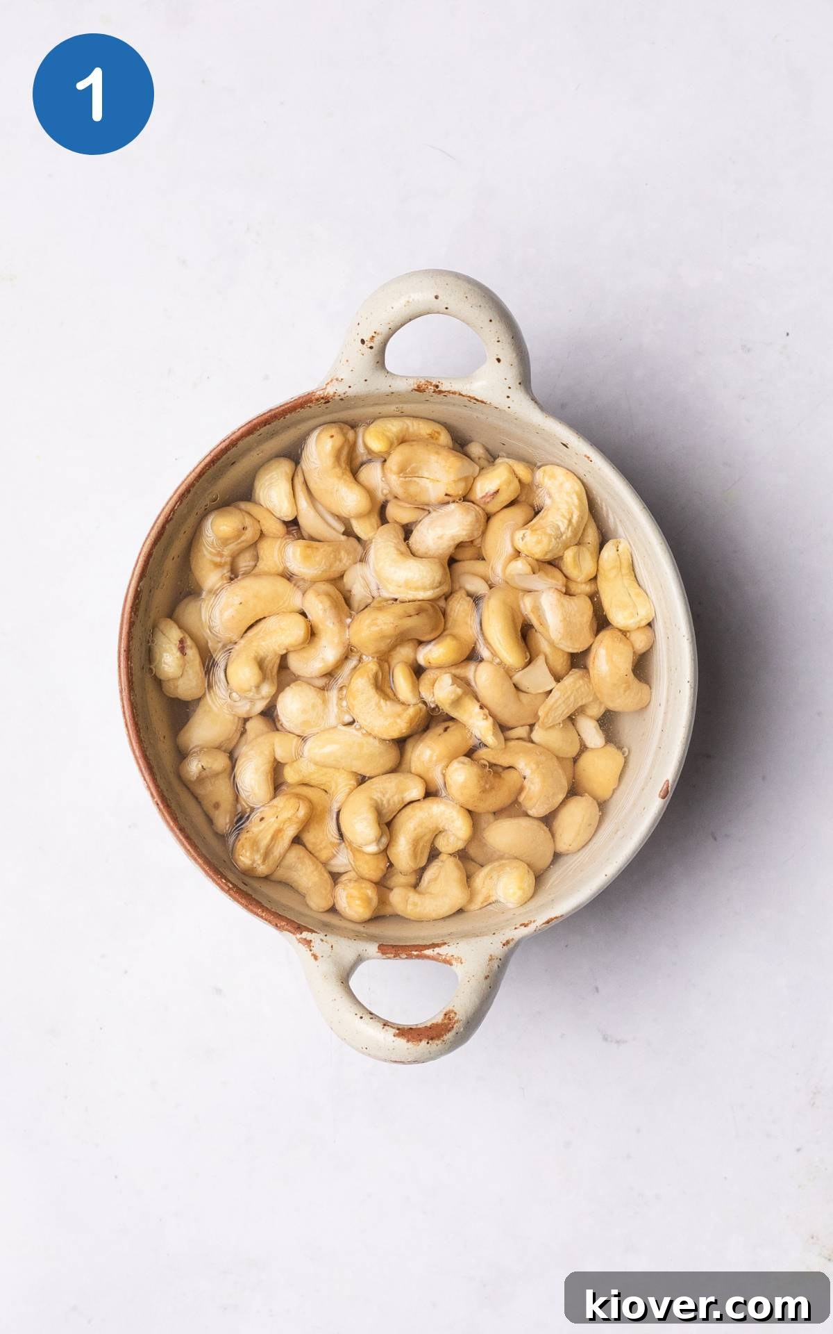 Creamy Vegan Sour Cream 4 Raw cashew nuts soaking in a bowl of boiling water to soften them for blending.