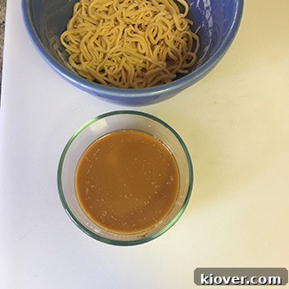 Beef Chow Mein: A Classic Stir-Fry Delight 4 Homemade noodles perfectly prepped alongside a bowl of rich stir-fry sauce, ready for the Beef Chow Mein.