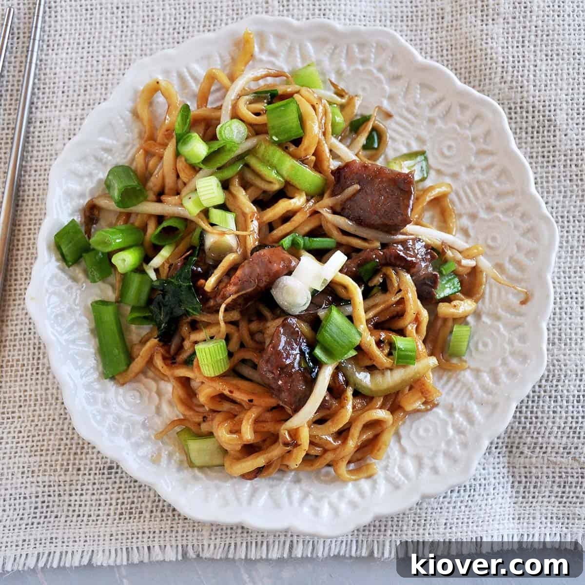 Beef Chow Mein Plate Overhead shot of a beautifully plated Beef Chow Mein, garnished and ready to serve.