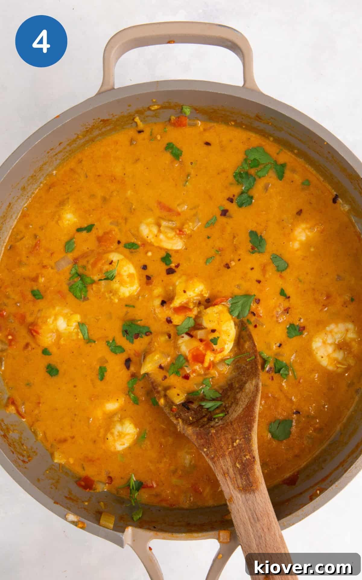 adding coconut milk and raw prawns.