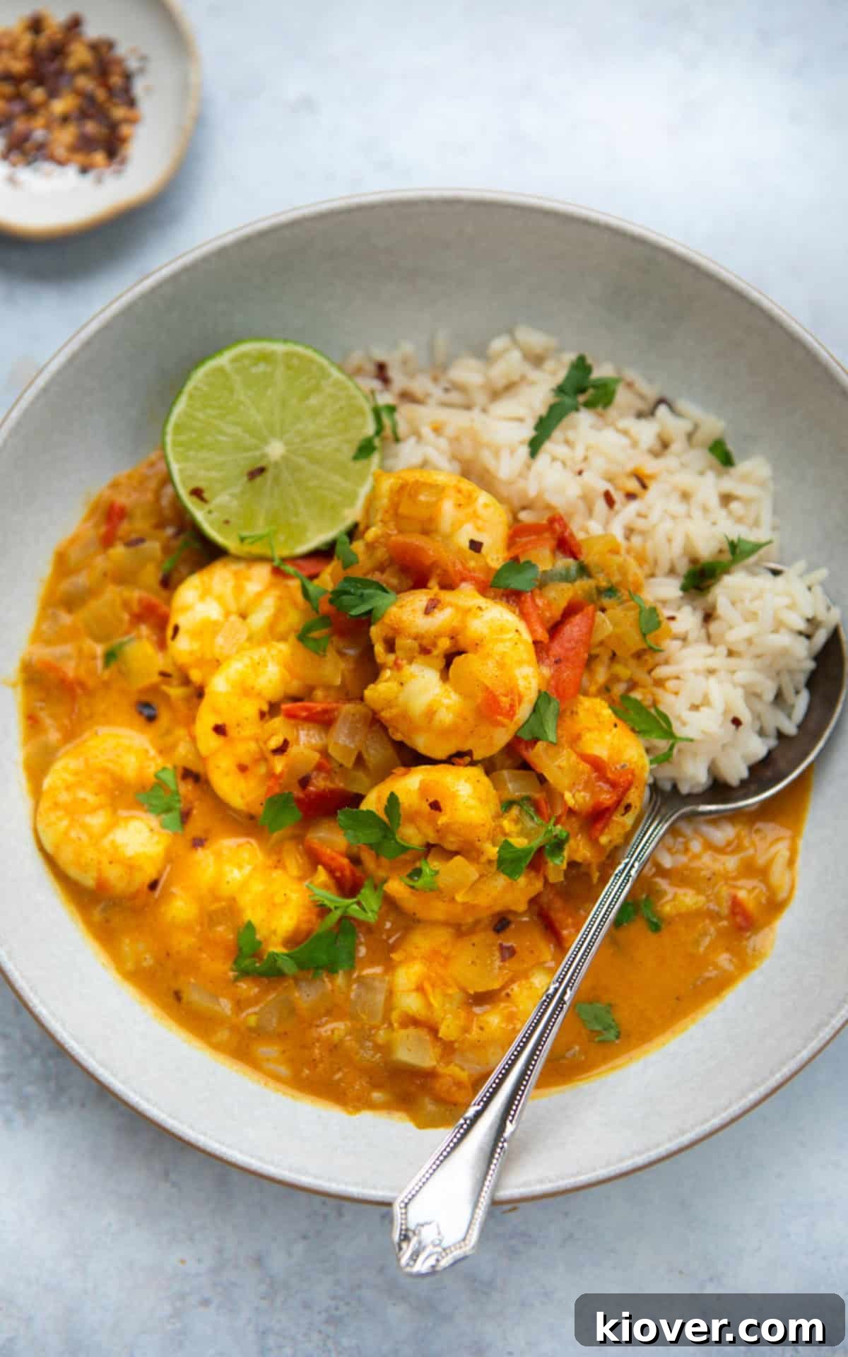 easy coconut prawn curry served on a plate with rice and lime