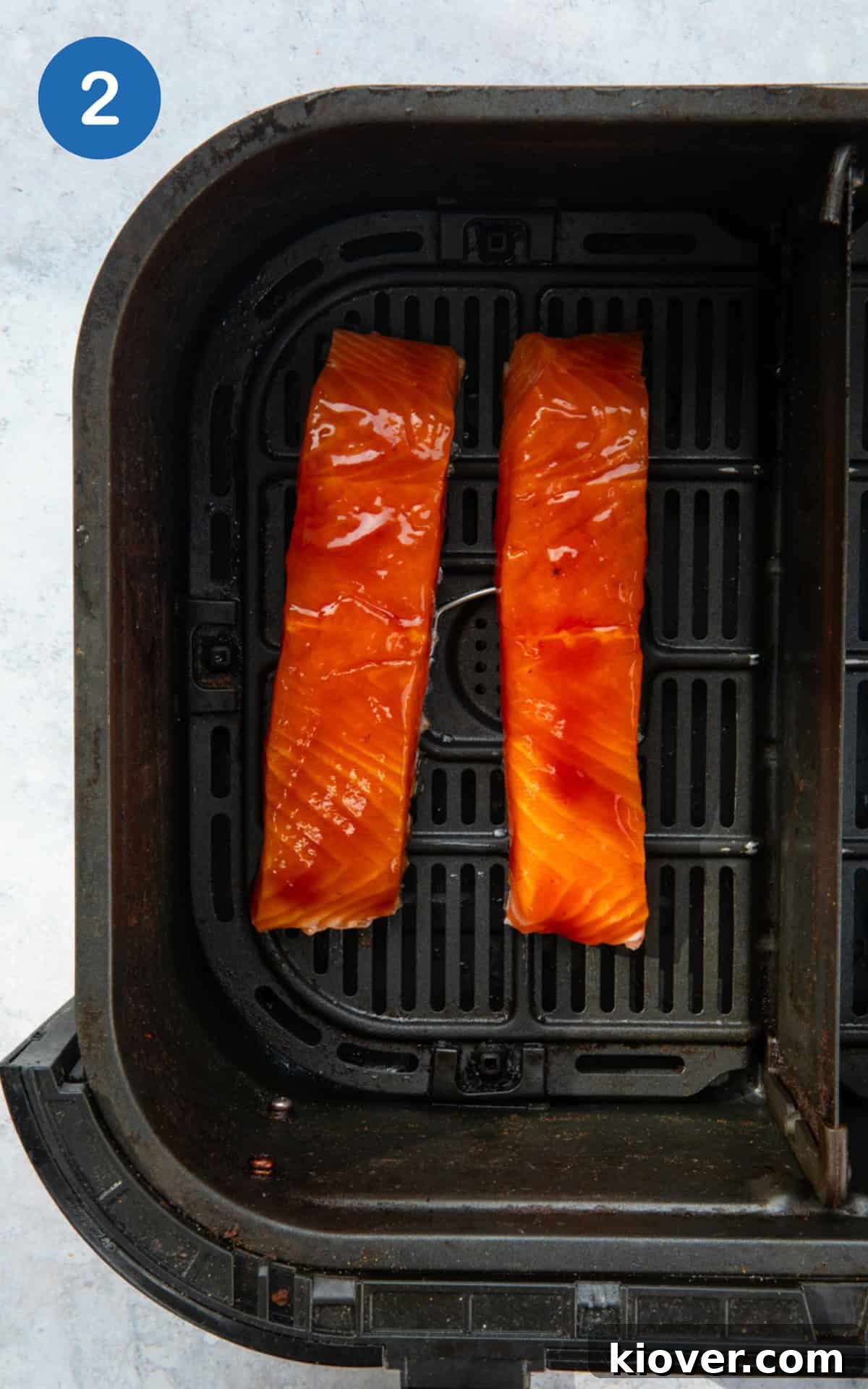 Salmon fillets cooking in an air fryer.