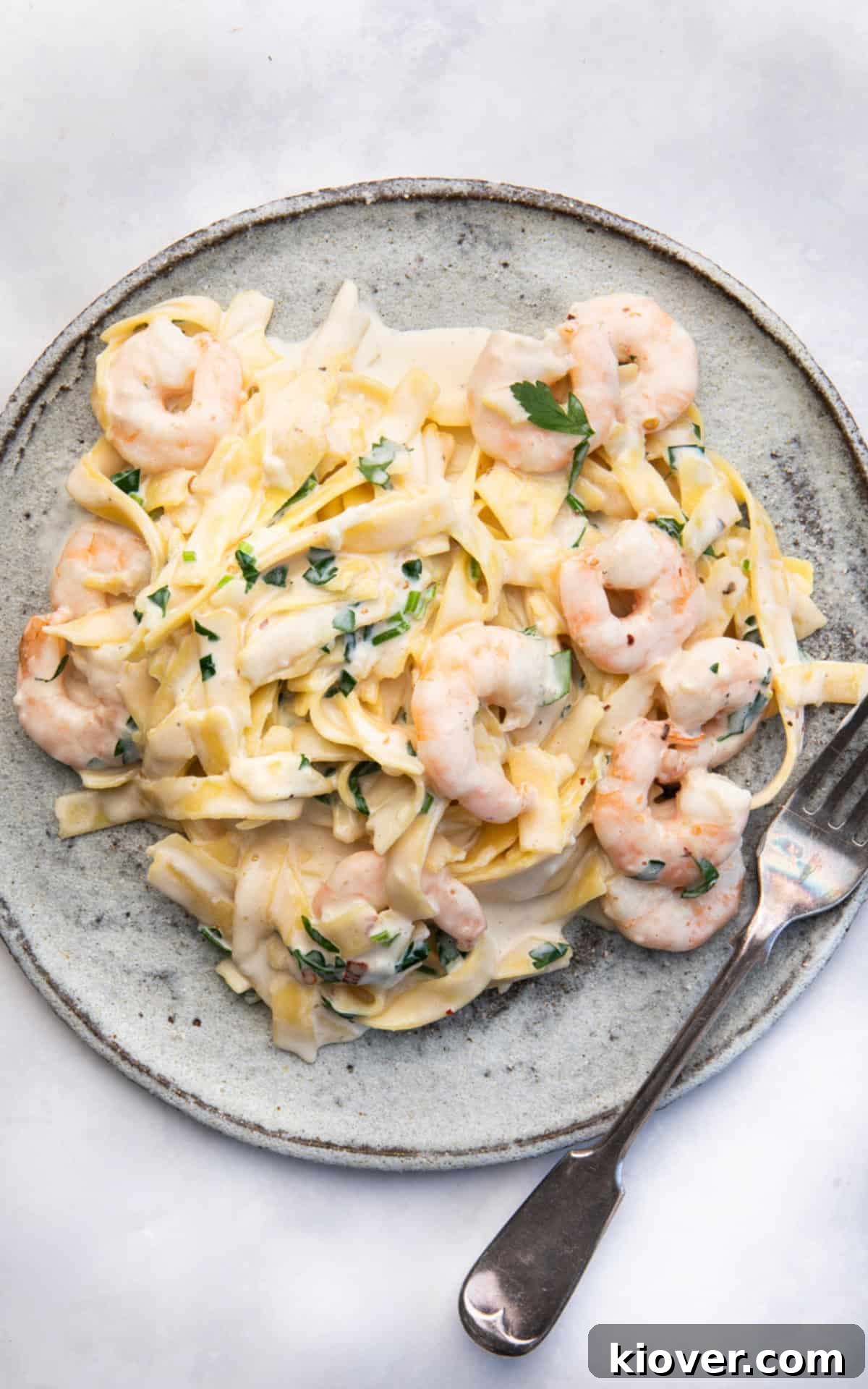 Lemon Garlic Prawn Linguine 8 A vibrant bowl of prawn noodles, garnished with fresh herbs, ready to be enjoyed.