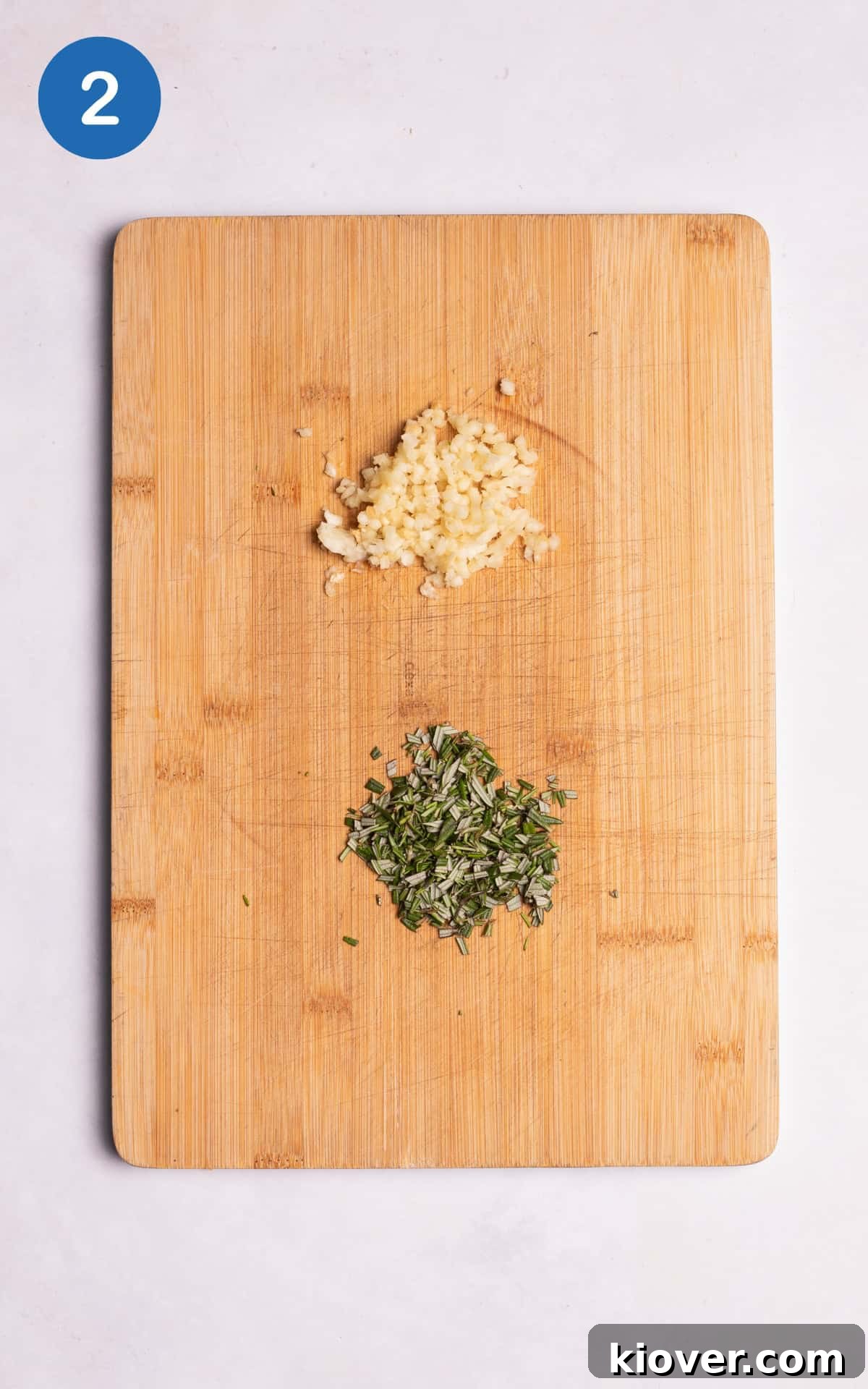 Golden Roasted Potato Cubes 5 Crushed garlic cloves and finely diced fresh rosemary ready to be added to potatoes.