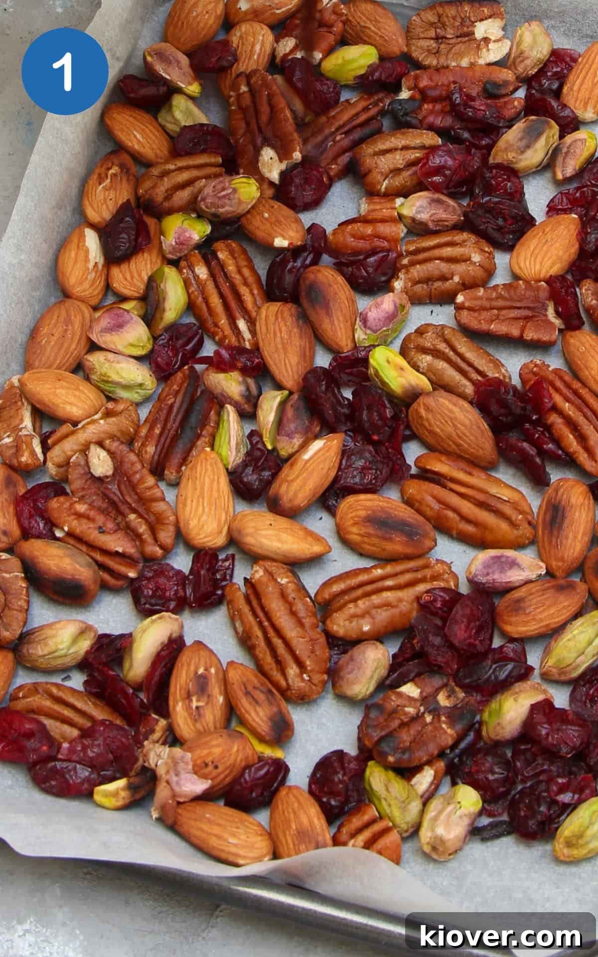 Plant-Based Rocky Road Delights 4 Toasted nuts and dried cranberries in a parchment-lined baking sheet.