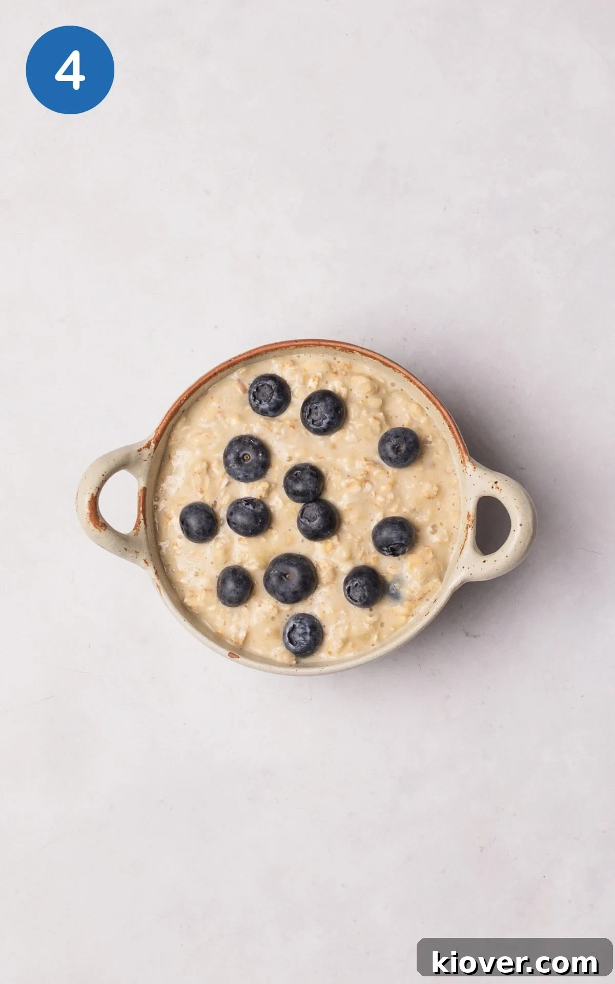 The oatmeal mixture poured into an ovenproof ramekin, topped with remaining blueberries.
