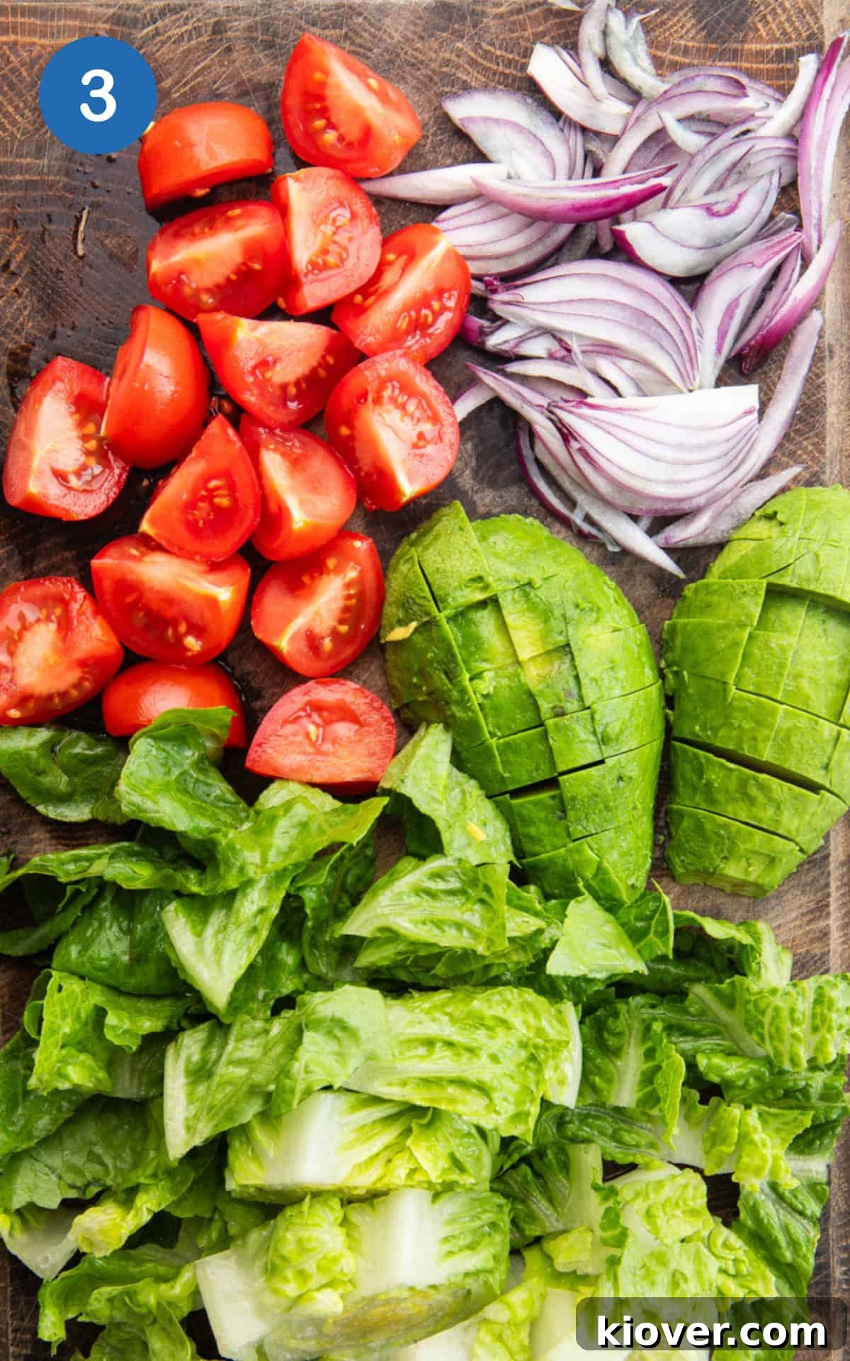 Vibrant Prawn Bowl 6 Romaine lettuce, tomatoes, avocado, and red onion on a cutting board, prepped for the salad.