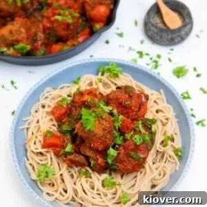Delicious Vegan Meatballs served with spaghetti and tomato sauce.