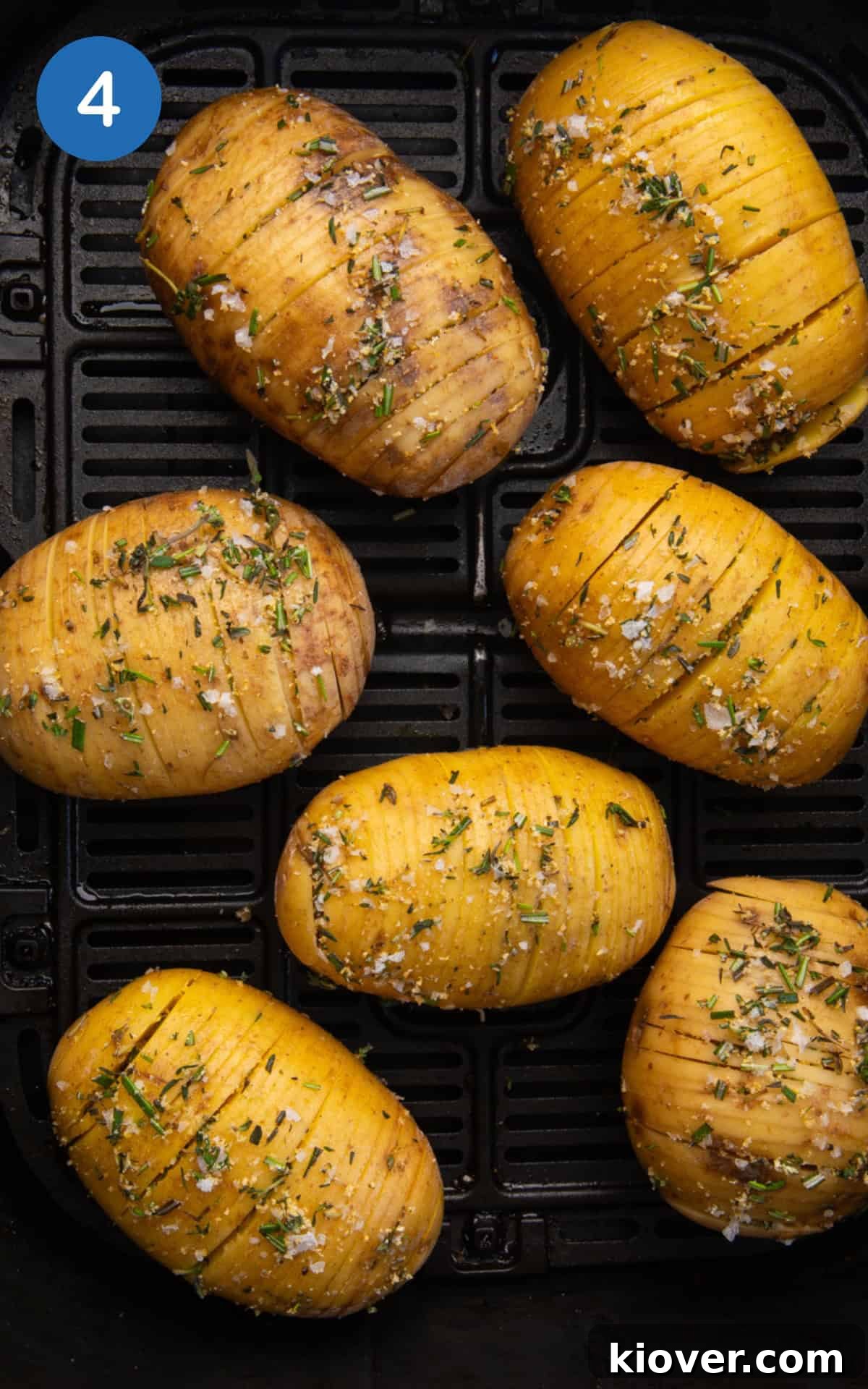 potatoes arranged in a single layer within an air fryer basket.