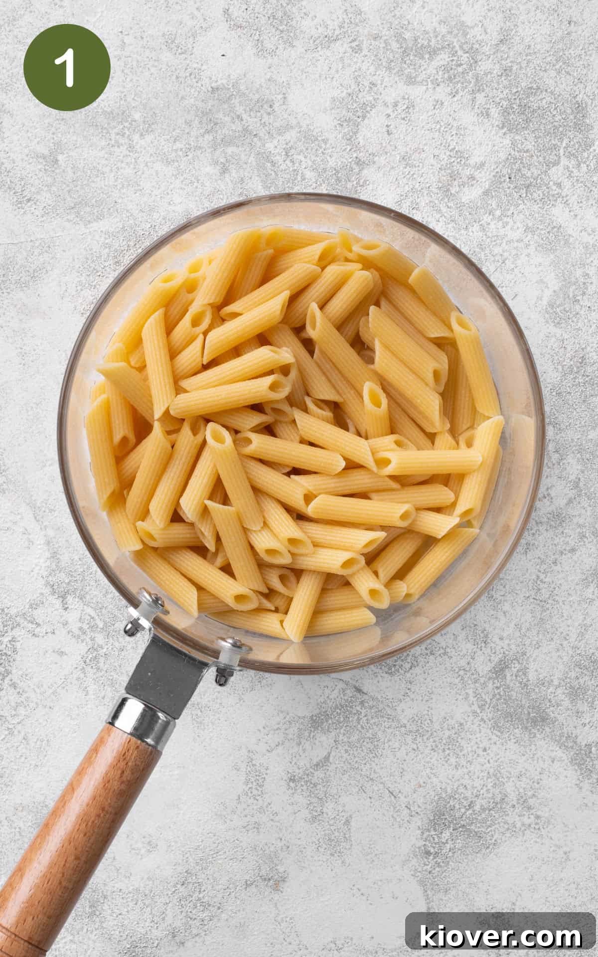 A pot of boiling salted water with pasta being cooked according to package directions.