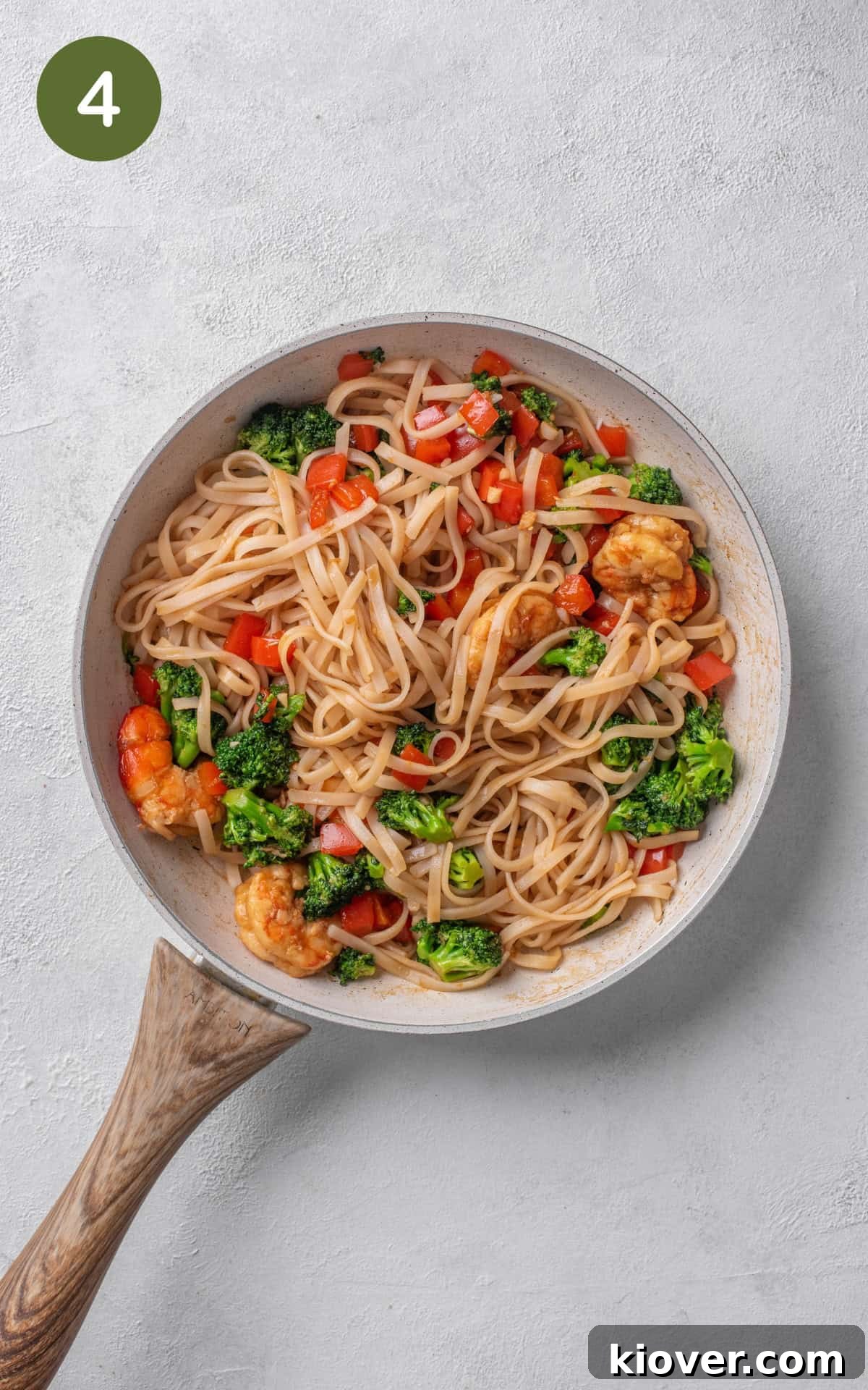 Savory Prawn Noodles 7 Adding sesame oil and cooked rice noodles to the pan.
