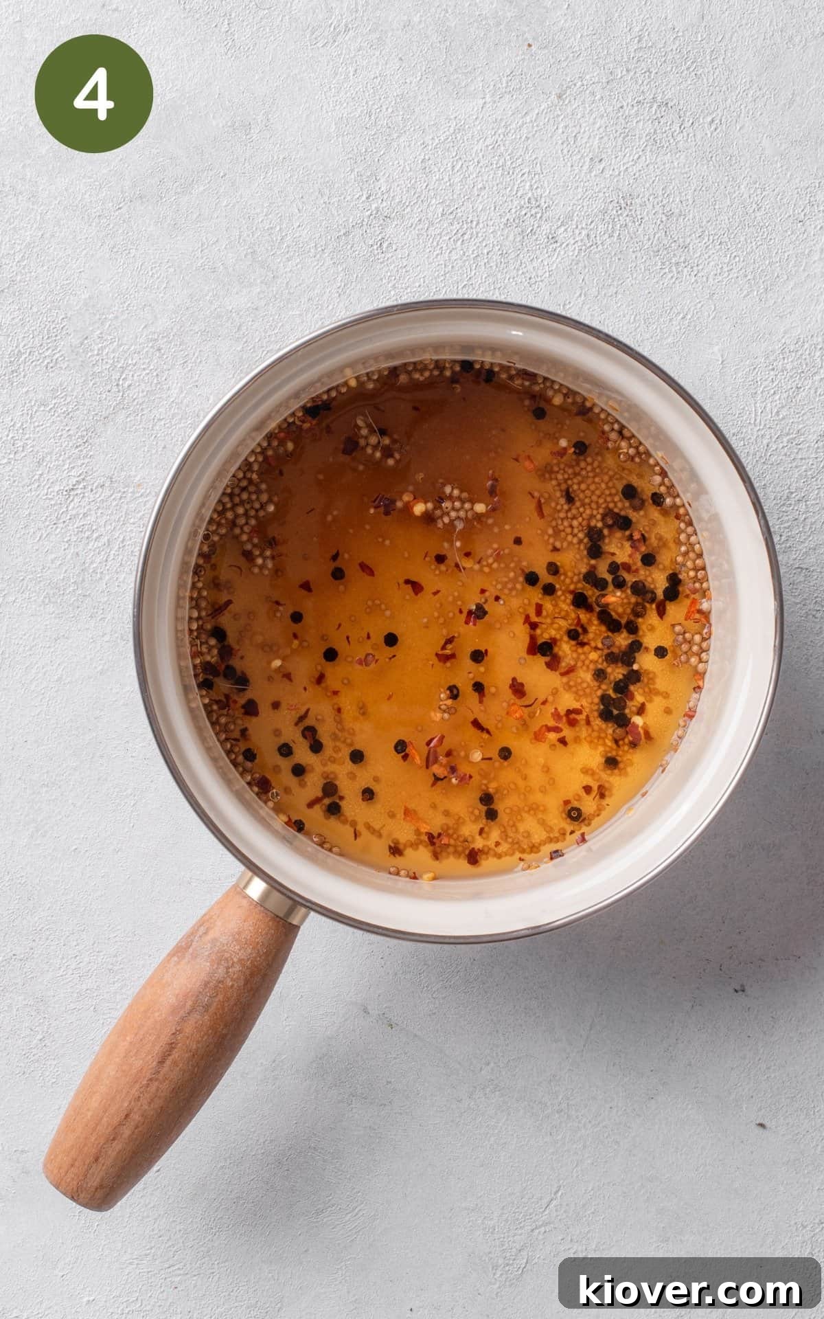 A pot on the stove, gently heating the pickling brine mixture to dissolve the sugar.
