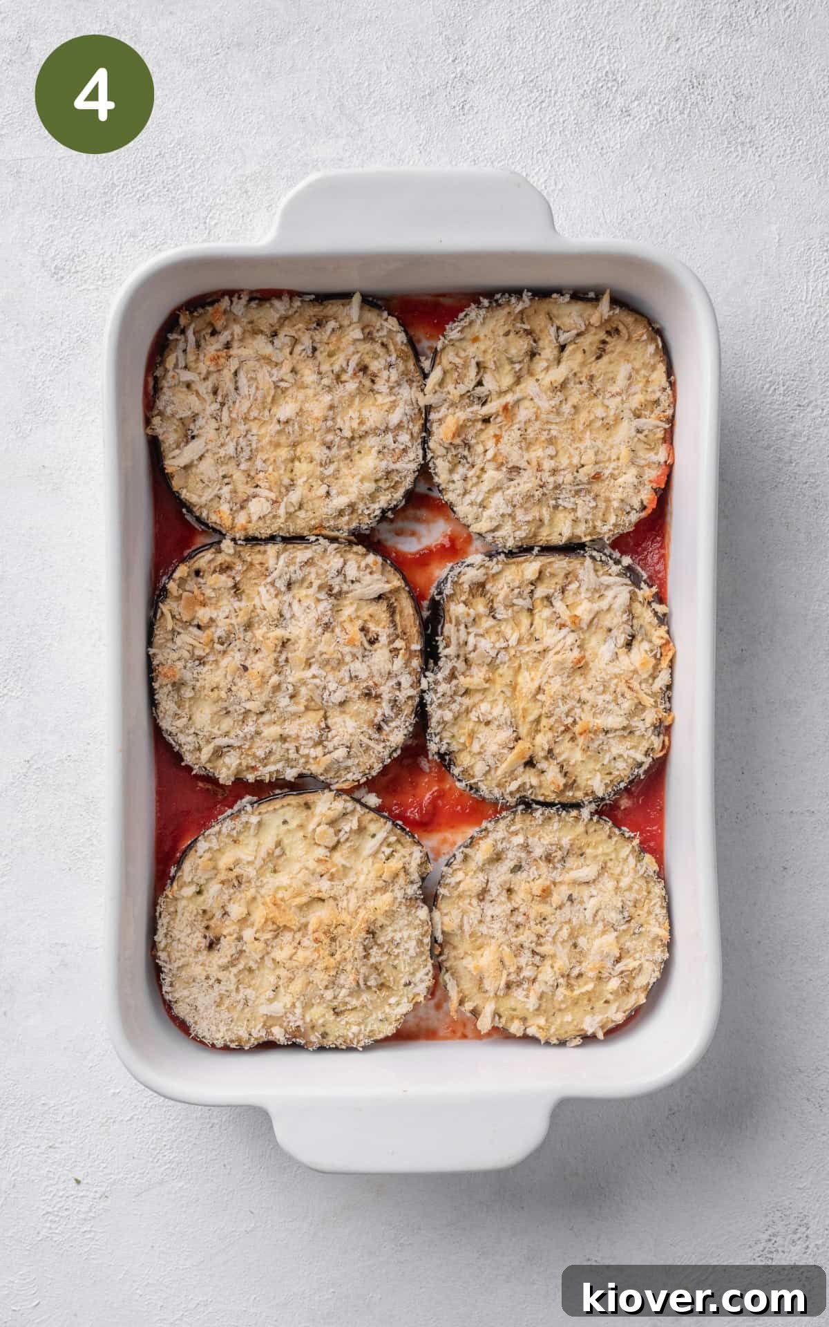 Italian Eggplant Comfort Bake 7 marinara sauce and aubergines in a baking dish.