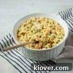 Rancharoni Macaroni in a large white dish and wooden spoon in it.