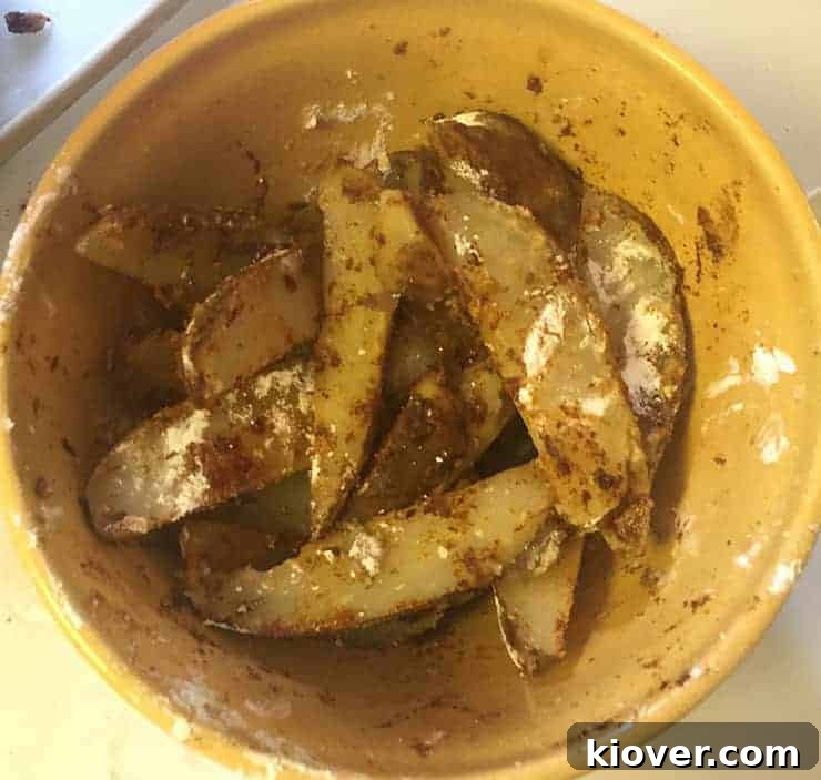 Coating potato wedges Following the boil and right after I mixed all the seasonings in with the potato wedges.