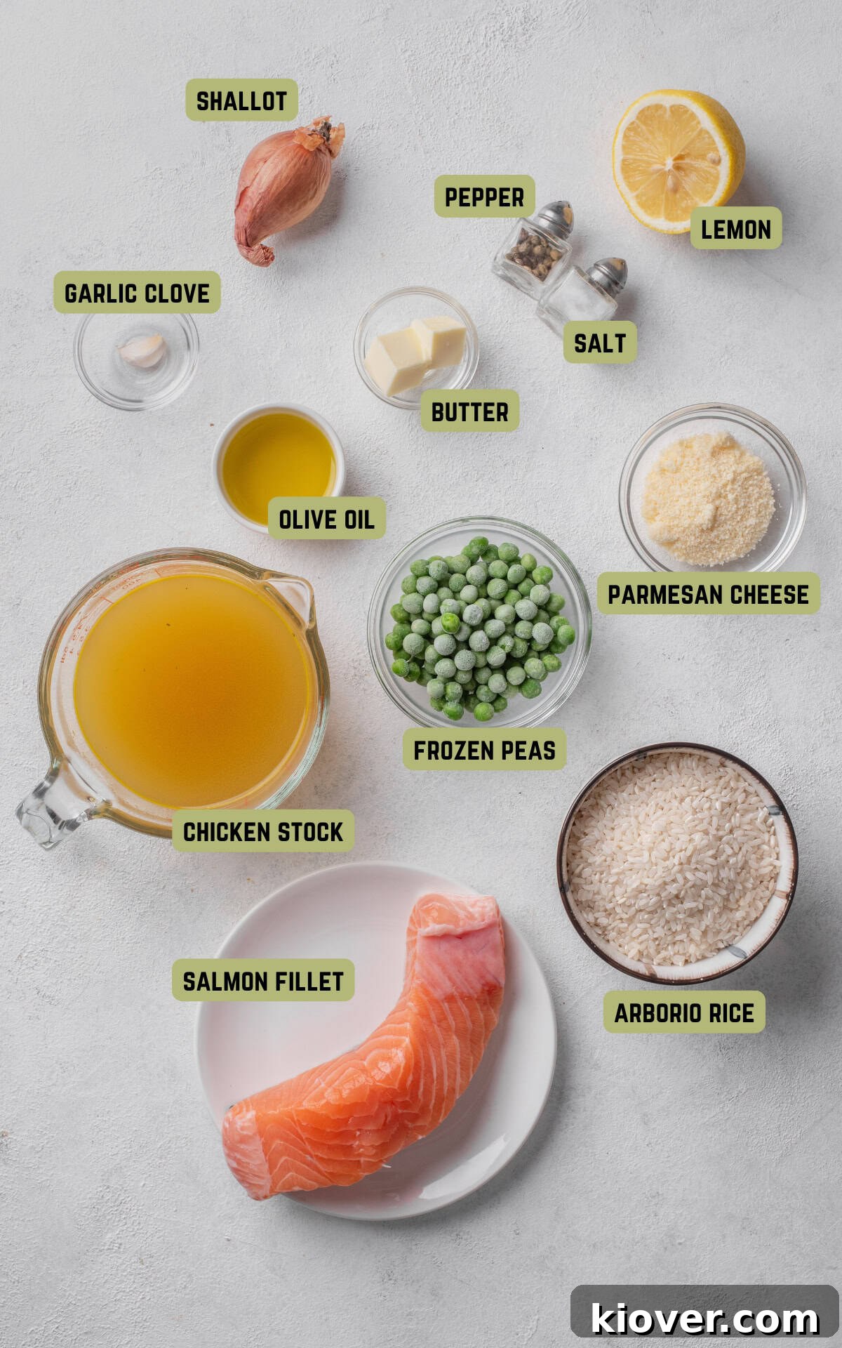 Fresh ingredients laid out for making salmon risotto, including salmon fillets, Arborio rice, lemon, garlic, and shallots.