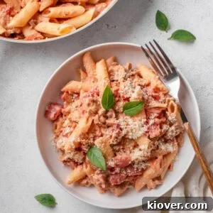 sausage pasta with tomatoes and parmesan.
