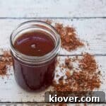 A pint mason jar filled with homemade tonic syrup, ready for mixing