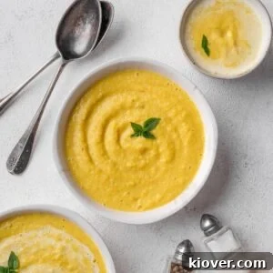 Curried parsnip soup served in a bowl, garnished.