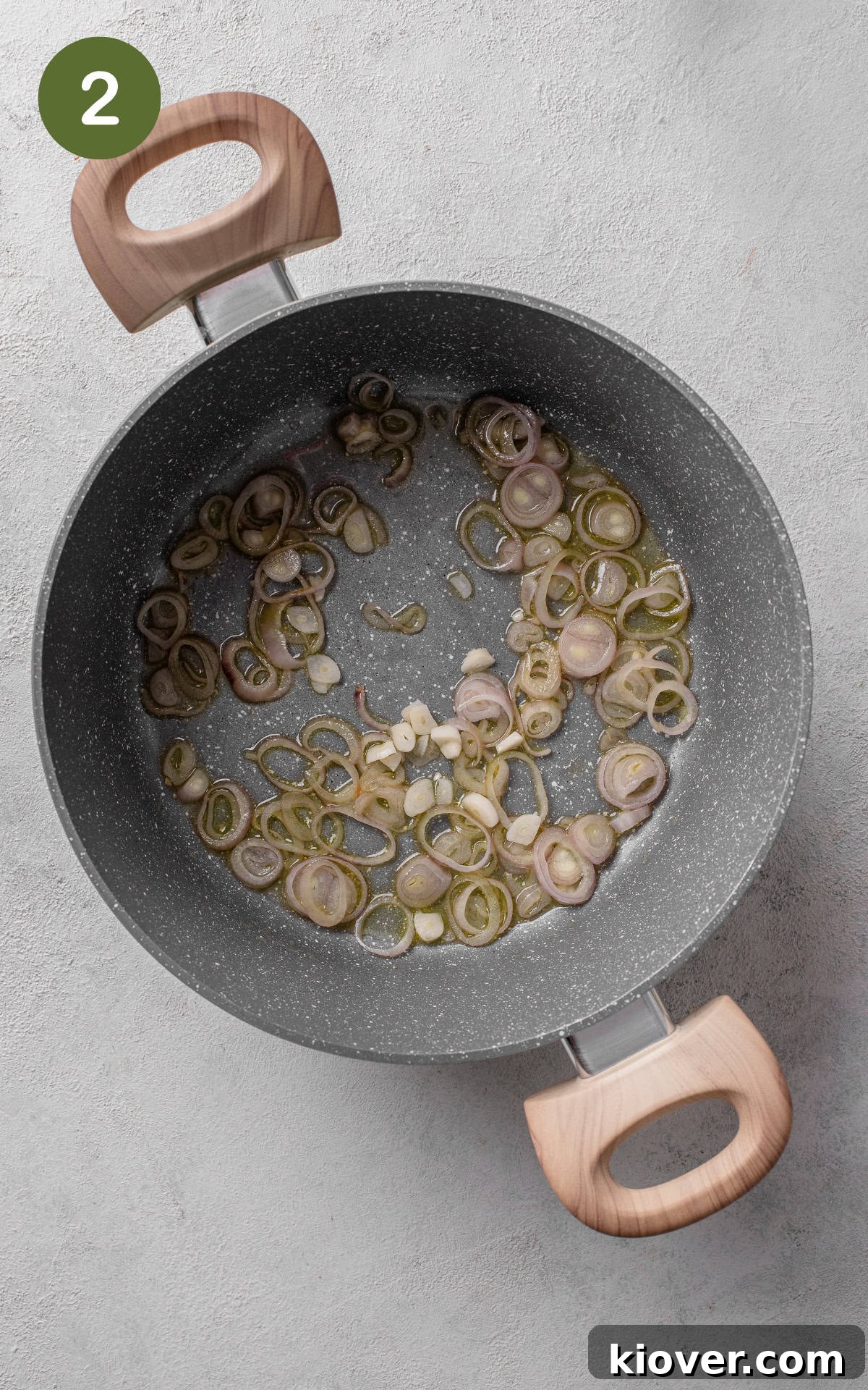 Silky Minted Pea Soup 5 Shallots and garlic being sautéed in olive oil in a stainless steel saucepot over medium-high heat.
